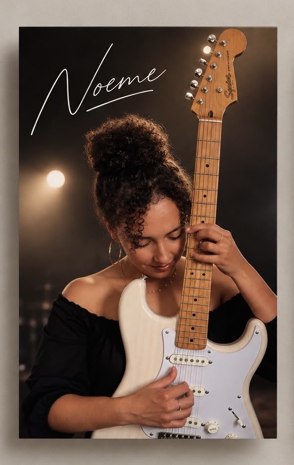 Noeme holding her white electric guitar beneath her signature