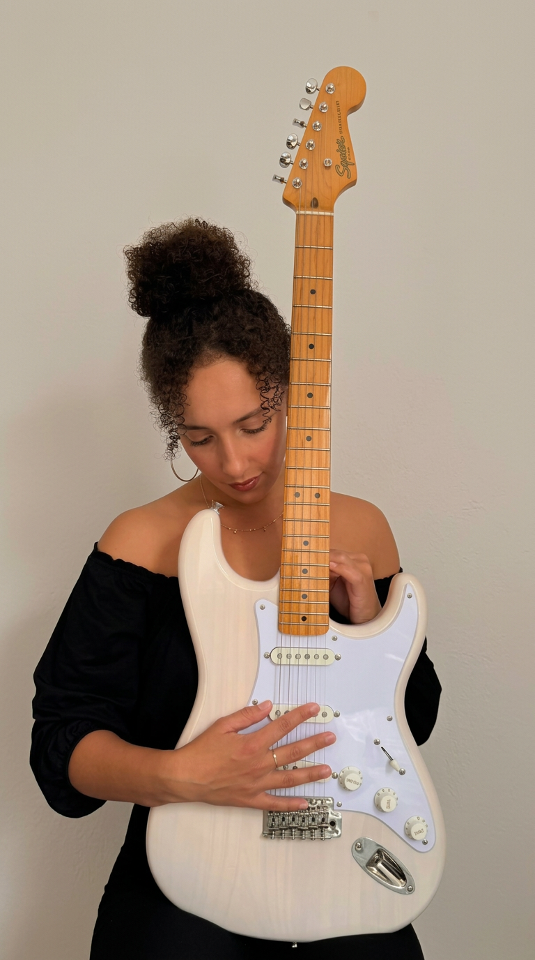 Noeme singing with her guitar